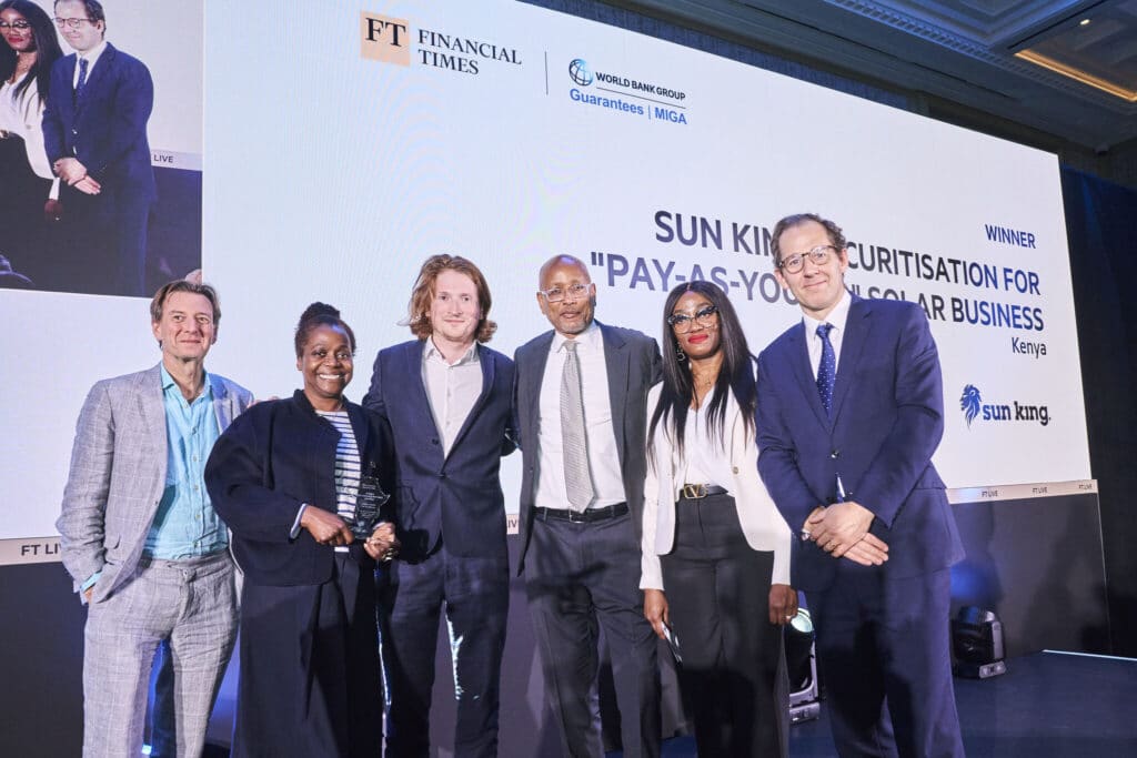 Image showing 6 people holding awards standing in front of a white projector screen.